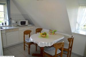 a kitchen with a table with chairs and a microwave at Lee - a05409 in Dunsum