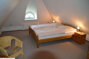 a bedroom with a bed and a window and a chair at Lee - a05409 in Dunsum