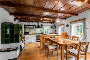 a kitchen with a wooden table and chairs at Vlčihorská chaloupka in Krásná Lípa