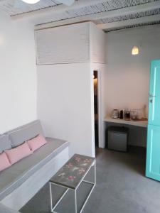 a living room with a couch and a table at Serifos Sugar Cubes in Serifos Chora