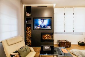 A television and/or entertainment centre at Fort D-Val luxurious apartment