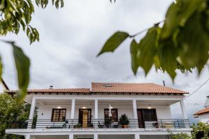 a white house with a red roof at Fort D-Val luxurious apartment in Ángistron