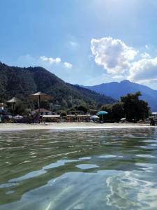 a view of a beach with mountains in the background at DeniaStella Apartments in Skala Potamias