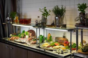 a display case filled with different types of food at Radisson Blu Marina Palace Hotel, Turku in Turku