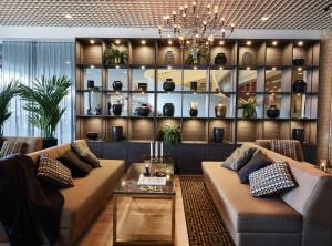 a living room filled with furniture and a coffee table at Radisson Blu Marina Palace Hotel, Turku in Turku
