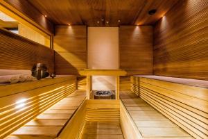 an empty sauna with wooden walls and wooden floors at Radisson Blu Marina Palace Hotel, Turku in Turku +110 photos
