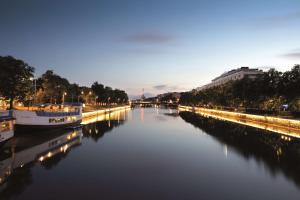 a river with boats on it at night at Radisson Blu Marina Palace Hotel, Turku in Turku