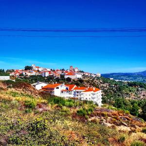 a group of white buildings on a hill at Dona Gracia Belmonte in Belmonte