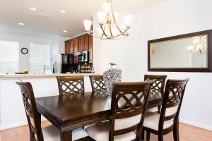 a dining room with a wooden table and chairs at 3Br 4 Bath Large Condo 5min Conv Center 1732ft in Orlando