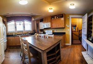 a kitchen with a wooden table and a wooden floor at Linda Sue Manor in Sioux City
