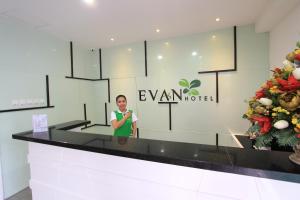 a woman standing in front of a hotel lobby at Evan Hotel Jambi in Jambi