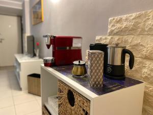 a kitchen with a counter with a coffee maker on it at Iris Apartment in Bari