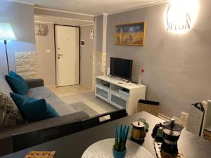 a living room with a couch and a tv at Iris Apartment in Bari