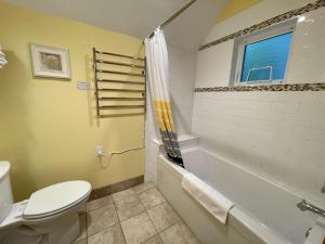 a bathroom with a toilet and a tub and a sink at One Bedroom Private Cabin Close To Trails And Beaches in Ucluelet