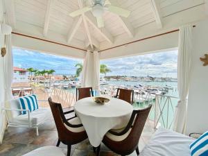a dining room with a table and a view of the water at Unique Luxury Pent House At Marina Casa De Campo in La Romana