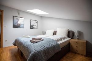 a bedroom with a bed with two towels on it at Apartments Kanevce Beach&Relax in Ohrid