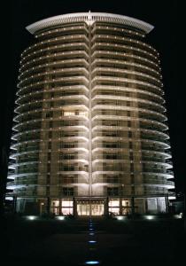 Un grand bâtiment est éclairé la nuit. dans l'établissement Exclusivo depto "Sea&Forest" frente mar P7 Mansa! parada 7 mansa - Punta del este, à Punta del Este