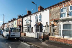 a white van parked on a street next to buildings at WGcDDE Large 3 Bedroom House - Parking - Garden in Hull