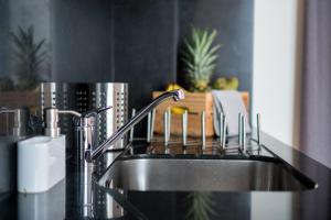 a kitchen sink with a faucet on a counter at Welcome Madeira Apartments in Funchal