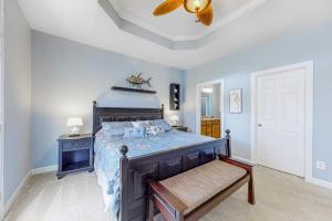 a bedroom with a bed and a ceiling fan at Sunset Island - 34 Seaside in Ocean City +52 photos