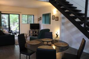 a living room with a table and chairs at GREEN TREES CHALET 10 minutes to Australia Zoo Landsborough Montville Maleny Caloundra Beaches Glasshouse mountains Big Kart Track National forest in Landsborough