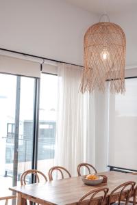 a dining room table with chairs and a chandelier at Ocean Oasis Port Campbell in Port Campbell