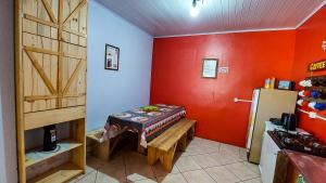 a kitchen with a table and a refrigerator in a room at Hostel Cape Town - Cambará do Sul in Cambará +52 photos