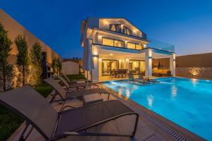 a villa with a swimming pool in front of a house at La Marbella Villa in Fethiye