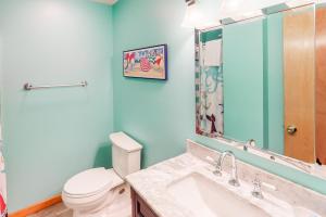 a bathroom with a toilet and a sink and a mirror at Beach Dreamer #4-BB in Buxton +18 photos