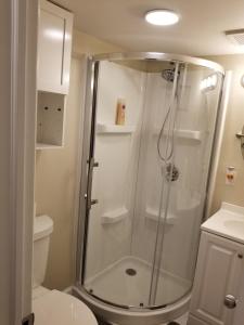 a bathroom with a shower and a toilet at The Airport Lodge in Collingdale