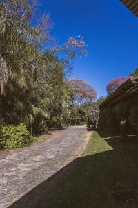 a dirt road with trees and a blue sky at Río Arriba Suites & Apartments & Restó in Bella Vista