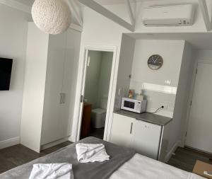 a bedroom with a bed and a microwave on a counter at Robe Nampara Cottages in Robe