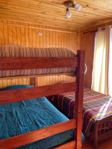 Postel nebo postele na pokoji v ubytování Cabañas y Centro Eventos Leyda + 14 fotografií