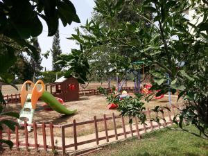 a park with a playground with a slide at Melodi Club Apart in Davutlar