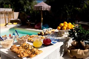 a buffet of food on a table next to a pool at L'Oasi Di Franco in Villa San Pietro