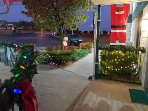 a house with christmas lights on the sidewalk at Ozark Valley Inn in Branson
