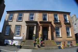 a building with stairs and flowers in front of it at The Salisbury Hotel in Edinburgh