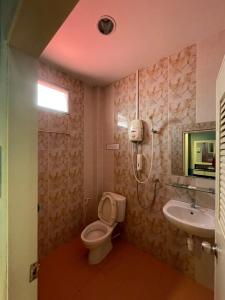 a bathroom with a toilet and a sink at Diamond Resort in Kanchanaburi