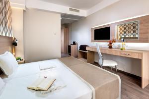 Cette chambre comprend un grand lit et un bureau. dans l'établissement Maria Palace Hotel - All Inclusive, à Sunny Beach