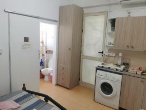 a bathroom with a washing machine in a room at Nicosia rooms Studios in Nicosia +69 photos