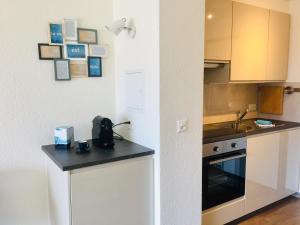 a kitchen with a counter top and a sink at Studios & Appartements famille - Saillon Evasion in Saillon +38 photos