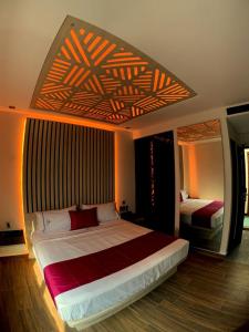 a bedroom with a large bed with a wooden floor at Amarterra Hotel Boutique in Mexico City