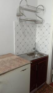 a kitchen with a sink and a counter top at Apartment Airkassa in Khujand