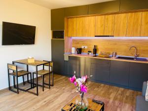 a kitchen with a vase of flowers on a table at Villa 112 in Dîrlos