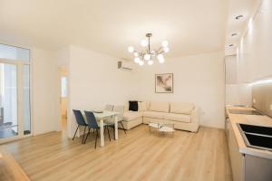 ein Wohnzimmer mit einem Sofa und einem Tisch in der Unterkunft Miku Apartment-Brand New at Wilson Square in Tirana