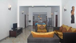 a living room with two couches and a television at NEW SITHI VILLAS in Hikkaduwa