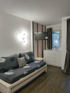 een woonkamer met een zwarte bank in een kamer bij Appartement - Résidence du golf deauville 2 in Deauville
