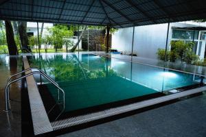 a swimming pool with a bench in front of a building at S RIVER RESORTS in Cochin