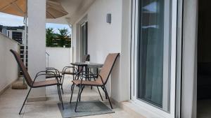 a patio with chairs and a table on a balcony at Astra Sarti Luxury Suites in Sarti