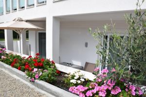 a garden of flowers in front of a building at Astra Sarti Luxury Suites in Sarti